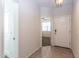 Well-lit foyer featuring tile floors, white walls, and open doorway to another room at 3029 S 78Th Dr, Phoenix, AZ 85043