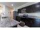 Modern kitchen with dark cabinets and stainless steel appliances at 3029 S 78Th Dr, Phoenix, AZ 85043