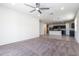 Living room featuring carpet flooring and an open layout to the kitchen area at 3029 S 78Th Dr, Phoenix, AZ 85043