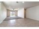 Bright living room featuring neutral walls, ceiling fan, and sliding doors to the backyard at 3029 S 78Th Dr, Phoenix, AZ 85043