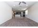 Living room boasts carpet flooring and seamless transition to kitchen space at 3029 S 78Th Dr, Phoenix, AZ 85043