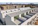 Aerial view of modern condos with patios, mountain views, and rooftop details under a partly cloudy sky at 312 E Windsor Ave # 2, Phoenix, AZ 85004