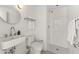 White bathroom featuring a walk-in shower, white tiles, a modern sink, and a round mirror at 312 E Windsor Ave # 2, Phoenix, AZ 85004