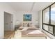 Bedroom featuring an upholstered headboard, art, large windows, and hardwood floors at 312 E Windsor Ave # 2, Phoenix, AZ 85004