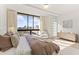 Bedroom with a city view framed by large windows, complemented by a modern dresser and soft decor at 312 E Windsor Ave # 2, Phoenix, AZ 85004