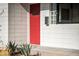 Close-up of a vibrant red front door with a unique white block wall exterior and modern mailbox at 312 E Windsor Ave # 2, Phoenix, AZ 85004