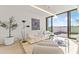 Modern living room with white sofa, hardwood floors, potted tree, and access to a balcony at 312 E Windsor Ave # 2, Phoenix, AZ 85004