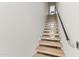 Modern staircase with wooden steps and black handrail leading to the upper level of the home at 312 E Windsor Ave # 2, Phoenix, AZ 85004