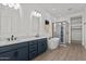 Luxurious bathroom features double sinks, a soaking tub, and a separate glass-enclosed shower at 32489 N 135Th Dr, Peoria, AZ 85383
