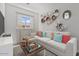 Cozy bedroom features a comfortable sectional, playful decor, and a window offering views of the outdoors at 32489 N 135Th Dr, Peoria, AZ 85383