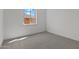 Well-lit bedroom featuring plush carpeting and a view from the bright window at 32489 N 135Th Dr, Peoria, AZ 85383