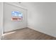 Neutral-toned bedroom with wood-look flooring, a window, and white walls for a bright, airy feel at 32489 N 135Th Dr, Peoria, AZ 85383