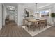 Inviting dining area showcases a wooden table and chairs, with natural light streaming through a window at 32489 N 135Th Dr, Peoria, AZ 85383