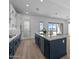 Modern kitchen featuring granite countertops, stainless steel appliances, a large island and a view to the outside at 32489 N 135Th Dr, Peoria, AZ 85383