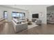 Bright living room features an expansive sectional sofa, area rug, and large picture window overlooking the exterior at 32489 N 135Th Dr, Peoria, AZ 85383