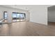Bright living room with wood-look tile floors and expansive sliding glass doors to the outdoor area at 32489 N 135Th Dr, Peoria, AZ 85383