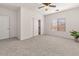 Bright bedroom with neutral carpet, a ceiling fan, and a large window for ample natural light at 330 E Cheyenne Rd, San Tan Valley, AZ 85143