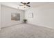 Large bedroom with neutral carpet, a ceiling fan, and a window offering natural light at 330 E Cheyenne Rd, San Tan Valley, AZ 85143