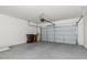 Well-lit garage featuring a functional door and plenty of space for parking and storage at 330 E Cheyenne Rd, San Tan Valley, AZ 85143