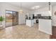 Bright kitchen features white cabinetry, stainless appliances, and sliding glass doors to the backyard at 330 E Cheyenne Rd, San Tan Valley, AZ 85143