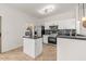 Well-lit kitchen with stainless steel appliances, a breakfast bar and lots of storage space at 330 E Cheyenne Rd, San Tan Valley, AZ 85143