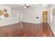 Open living room with hardwood floors and ceiling fan showcasing a seamless flow throughout the home at 330 E Cheyenne Rd, San Tan Valley, AZ 85143