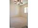 Bright bedroom with neutral carpet, ceiling fan, and a window bringing in natural light at 3648 E Perkinsvile St, Gilbert, AZ 85295