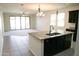 Modern kitchen with dark cabinetry, granite countertops, an island with a sink, and open layout at 3648 E Perkinsvile St, Gilbert, AZ 85295