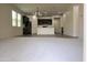 Open floor plan with carpeted living room flowing into a kitchen with a center island at 3648 E Perkinsvile St, Gilbert, AZ 85295