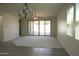 Bright living room with carpet flooring, sliding glass doors to the backyard, and neutral walls at 3648 E Perkinsvile St, Gilbert, AZ 85295