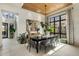 Bright dining room featuring a wood-paneled ceiling, modern lighting, and large windows with views of the home's outdoor scenery at 37200 N Cave Creek Rd # 1072, Scottsdale, AZ 85262