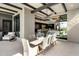 Covered patio dining area with a view into the home, featuring a modern ceiling fan, outdoor furniture, and stylish decor at 37200 N Cave Creek Rd # 1072, Scottsdale, AZ 85262