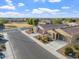 Well-maintained homes with desert landscaping and private driveways adjacent to a spacious green park at 378 W Satinka Dr, San Tan Valley, AZ 85140