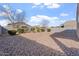 Spacious gravel backyard with shrubs and block fencing at 378 W Satinka Dr, San Tan Valley, AZ 85140