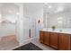 Bright bathroom featuring double sinks, spacious shower with glass door, and modern fixtures at 378 W Satinka Dr, San Tan Valley, AZ 85140