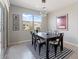 Bright dining room with modern lighting, a striped rug, and a large window at 378 W Satinka Dr, San Tan Valley, AZ 85140