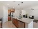 Well-lit kitchen with stainless steel appliances, granite counters, and a large island at 378 W Satinka Dr, San Tan Valley, AZ 85140