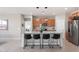 Modern kitchen island features barstool seating, granite countertops, and pendant lighting at 378 W Satinka Dr, San Tan Valley, AZ 85140