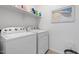 Bright laundry room with modern appliances and extra storage shelves at 378 W Satinka Dr, San Tan Valley, AZ 85140