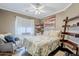 Charming bedroom with floral bedding, a rocking chair, and natural light from the window at 39935 N Passaro Dr, San Tan Valley, AZ 85140