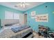 A bedroom features a ceiling fan, motivational poster, and leopard print comforter at 39935 N Passaro Dr, San Tan Valley, AZ 85140