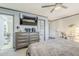 Bright bedroom featuring a dresser with a TV, a ceiling fan, and soft natural light at 39935 N Passaro Dr, San Tan Valley, AZ 85140