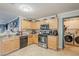 Functional kitchen with wooden cabinets, modern appliances, and durable tile flooring at 39935 N Passaro Dr, San Tan Valley, AZ 85140