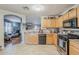 Well-lit kitchen featuring stainless steel appliances and an open layout to the living area at 39935 N Passaro Dr, San Tan Valley, AZ 85140