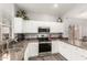 Bright kitchen with granite counters, stainless steel appliances, and abundant cabinet space at 40656 N Key Ln, Anthem, AZ 85086