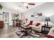 Open-concept living area with modern wood floors, ceiling fan, and adjacent dining space at 40656 N Key Ln, Anthem, AZ 85086