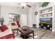 Bright living room featuring a ceiling fan, modern wood floors, and built-in shelving at 40656 N Key Ln, Anthem, AZ 85086