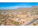 Aerial shot showcasing a property with desert surroundings, mountain views, and nearby residential neighborhood at 4188 N Plaza Dr, Apache Junction, AZ 85120