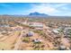 Vibrant aerial view showcasing a tranquil desert home with horse property, mountain views, and the stunning Arizona sky at 4188 N Plaza Dr, Apache Junction, AZ 85120