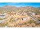 Expansive aerial view of a desert community nestled against picturesque mountains under a clear blue sky at 4188 N Plaza Dr, Apache Junction, AZ 85120